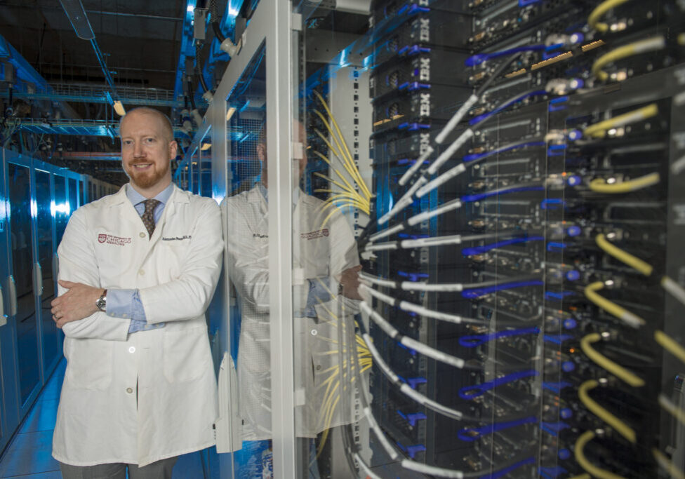 Alexander T Pearson, MD PhD, Associate Professor of Medicine at the University of Chicago, Director of Data Sciences and Director of Head/Neck Cancer in the Section of Hematology/Oncology. Dr. Pearson is a leading voice in applying quantitative methods to cancer research poses for a portrait with computer servers in Chicago on Tuesday, Aug. 27, 2024. Photo by Mark Black